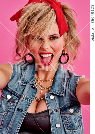 Keep rocking your style. Studio shot of a beautiful young woman wearing a 80s outfit. Keep rocking your style. Studio shot of a beautiful young woman wearing a 80s outfit. 86649125