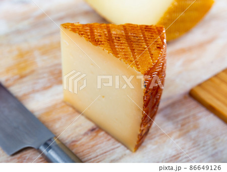 View of a piece of semi-hard cheese View of a piece of semi-hard cheese 86649126