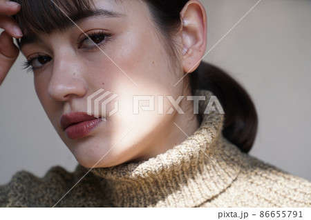 セーターを着た女性の陰影のあるポートレート セーターを着た女性の陰影のあるポートレート 86655791