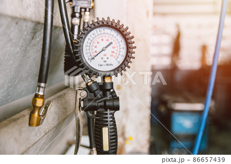 Tire Air pump head with pressure gauge service for car inflation in garage Tire Air pump head with pressure gauge service for car inflation in garage 86657439