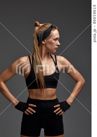 Portrait of female anger, animal instinct, demonstrating their incredible flexibility with the movement of animal flow in the studio on a gray background. 86658619