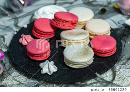 Macaroons. Delicious french desserts. Macaroons with raspberries and cream cheese. Macaroons on the table 86661226
