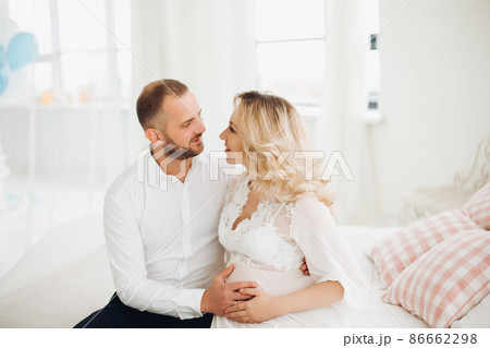 Beautiful couple embracing stomach and touching Beautiful couple embracing stomach and touching 86662298