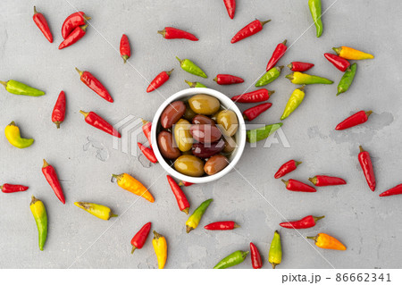 Chili peppers and marinated olives on gray background 86662341