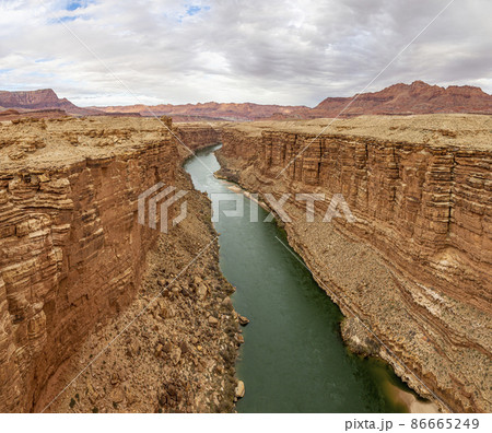 Panoramic view on green colored colorado river from Navajo bridge in winter Panoramic view on green colored colorado river from Navajo bridge in winter 86665249