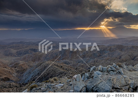 Image of a spectacular weather scene with impressive sun rays through a hole in the clouds 86668285
