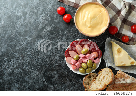Concept of delicious food with fondue on black smokey table 86669275