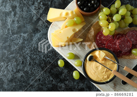 Concept of delicious food with fondue on black smokey table 86669281