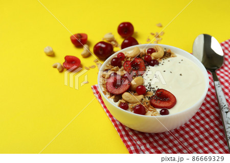 Concept of tasty breakfast with yogurt on yellow background Concept of tasty breakfast with yogurt on yellow background 86669329