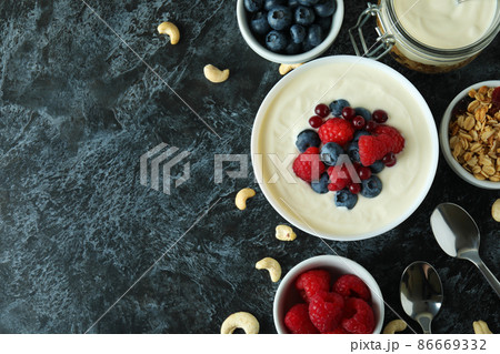 Concept of tasty breakfast with yogurt on black smokey table Concept of tasty breakfast with yogurt on black smokey table 86669332