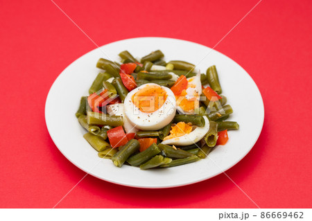 salad green beans, pepper and boiled eggs on plate salad green beans, pepper and boiled eggs on plate 86669462