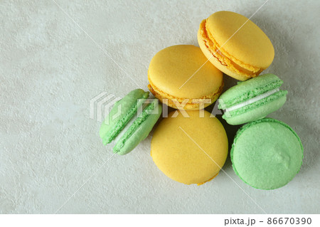 Concept of tasty dessert with macaroons on white textured background 86670390