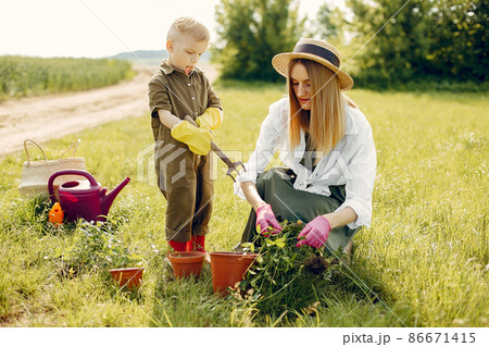 Beautiful mother with little son in a summer field Beautiful mother with little son in a summer field 86671415