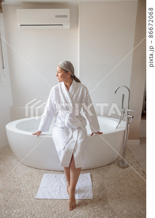 Beautiful lady getting ready to take bath Beautiful lady getting ready to take bath 86672068