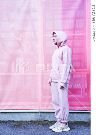 A young woman on an isolated pink background. She stands and looks away with a thoughtful face. High quality photo A young woman on an isolated pink background. She stands and looks away with a thoughtful face. High quality photo 86672813