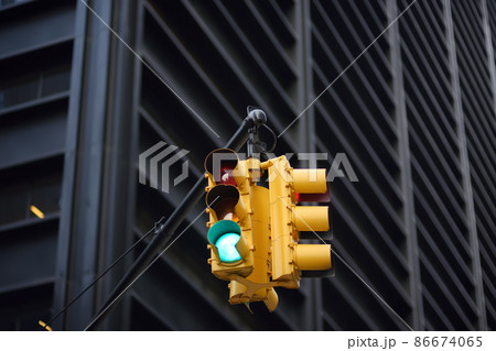 Yellow Traffic Light on background of skyscrapers, Manhattan, New York, USA. Green stop signal. Yellow Traffic Light on background of skyscrapers, Manhattan, New York, USA. Green stop signal. 86674065