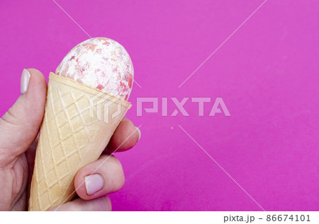 Vanilla ice cream waffle horns with decoration eggs on pink background. Minimalism. Creative Easter concept. Studio Photo 86674101