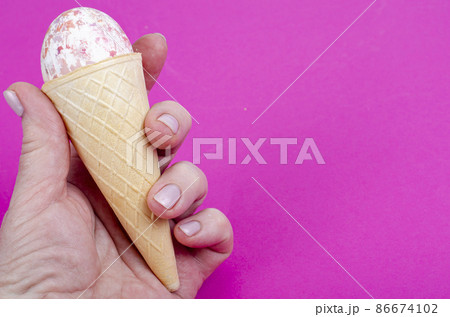 Vanilla ice cream waffle horns with decoration eggs on pink background. Minimalism. Creative Easter concept. Studio Photo 86674102