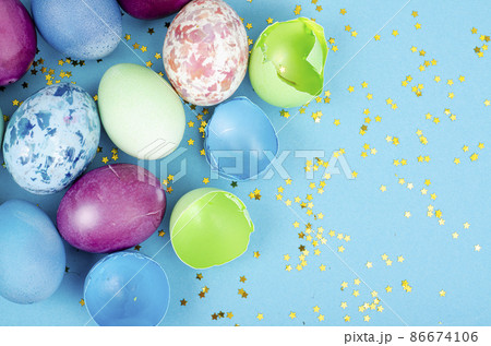 Decorated handmade Easter eggs for the holiday season on blue background. Creative minimal abstract concept. Studio Photo 86674106