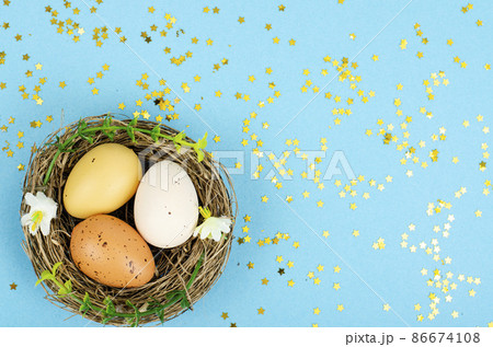 Decorated handmade Easter eggs for the holiday season on blue background. Creative minimal abstract concept. Studio Photo 86674108