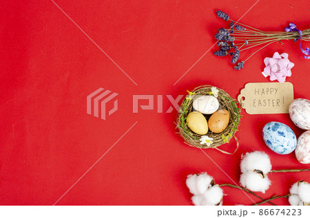 Multicolored handmade easter eggs and confetti on pink background. Minimal concept. View from above. Space for text. Studio Photo 86674223