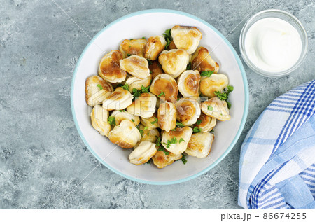 Blue bowl with fried dumplings. Studio Photo 86674255