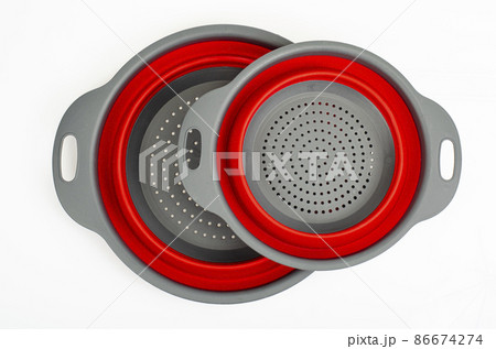 Bicolor collapsible colander on white background. Studio Photo Bicolor collapsible colander on white background. Studio Photo 86674274