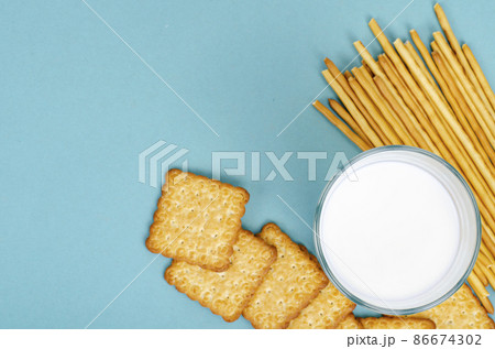 Delicious cookies and glass of milk on bright background. Studio Photo Delicious cookies and glass of milk on bright background. Studio Photo 86674302