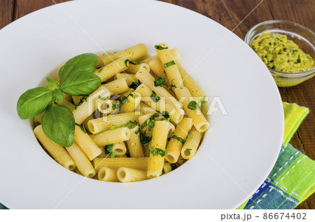 Penne pasta with pesto sauce. Italian cuisine. Penne pasta with pesto sauce. Italian cuisine. 86674402
