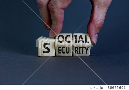 Social security symbol. Businessman turns wooden cubes and changes the word 'social' to 'security' or vice versa. Beautiful grey background, copy space. Business, social security concept. Social security symbol. Businessman turns wooden cubes and changes the word 'social' to 'security' or vice versa. Beautiful grey background, copy space. Business, social security concept. 86675691