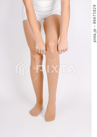 Medical Compression Stockings for varicose veins and venouse therapy. Compression Hosiery. Sock for sports isolated on white background. Beige color socks mock up for advertising, branding, design. Medical Compression Stockings for varicose veins and venouse therapy. Compression Hosiery. Sock for sports isolated on white background. Beige color socks mock up for advertising, branding, design. 86675829