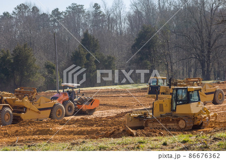 Excavator doing moving soil construction works landscaping works on construction 86676362