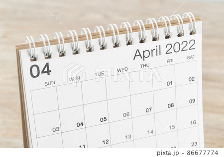 April 2022 desk calendar on wooden background. April 2022 desk calendar on wooden background. 86677774