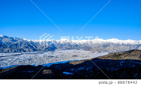 鷹狩山から望む冬の北アルプスと大町市の町並み 鷹狩山から望む冬の北アルプスと大町市の町並み 86678442