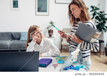 Mother controls her daughter to learn her lessons 86680606