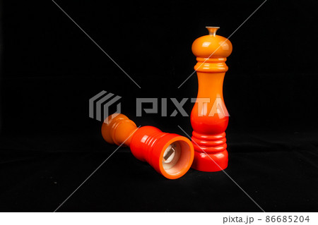 Salt and pepper mills or grinders on a black background. Salt and pepper mills or grinders on a black background. 86685204
