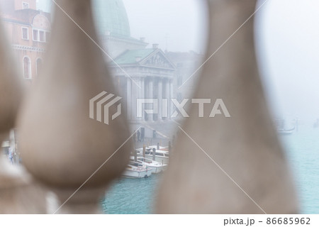 View through bridge fence on boats and old building View through bridge fence on boats and old building 86685962