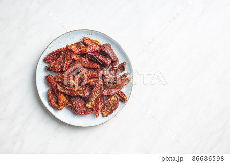 Sun dried tomatoes on plate. Sun dried tomatoes on plate. 86686598