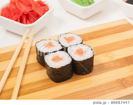sushi roll with salmon in nori seaweed on a wooden Board 86687447