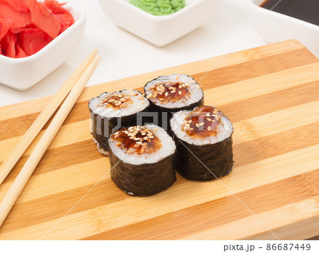 sushi roll with eel in seaweed nori on a wooden Board sushi roll with eel in seaweed nori on a wooden Board 86687449