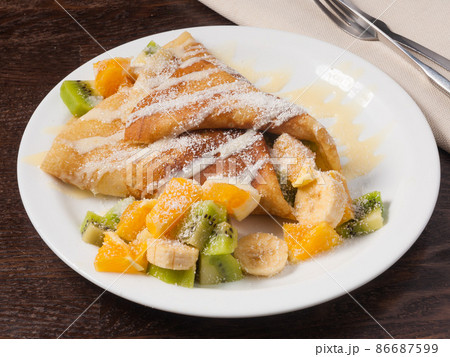 pancake with fruit orange banana kiwi and condensed milk pancake with fruit orange banana kiwi and condensed milk 86687599
