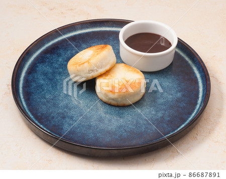 Cottage cheese pancakes with a chocolate topping. Concept Cottage cheese pancakes with a chocolate topping. Concept 86687891