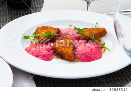 fried cheese fries with berry sauce in the restaurant 86688512