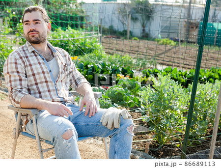 Farmer resting after work on the field Farmer resting after work on the field 86689113