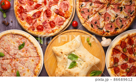 assorted pizzas on a wooden table. top view assorted pizzas on a wooden table. top view 86689612