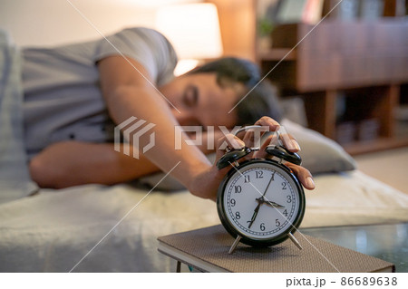 muslim man in the bed turning the alarm off muslim man in the bed turning the alarm off 86689638