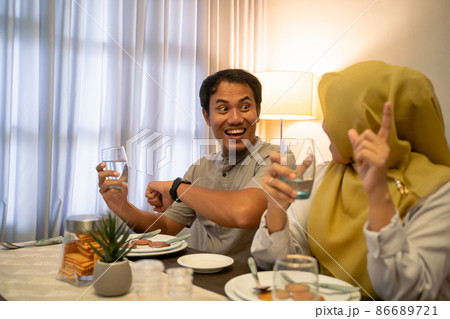 excited couple having iftar dinner time together excited couple having iftar dinner time together 86689721