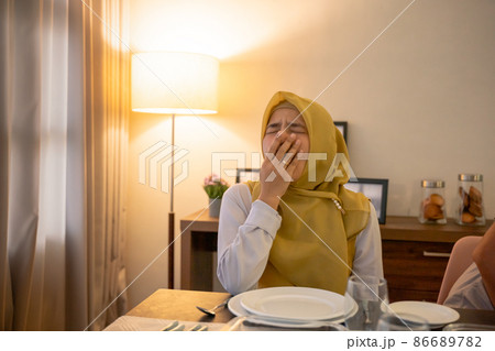 tired woman having break fast or sahur in the morning tired woman having break fast or sahur in the morning 86689782