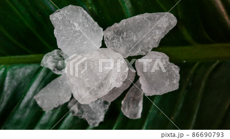 Crystal clear alum cubes or Potassium alum on green leaf. Chemical compound substance. Concept for beauty , spa and underarm treatment industrial. Crystal clear alum cubes or Potassium alum on green leaf. Chemical compound substance. Concept for beauty , spa and underarm treatment industrial. 86690793