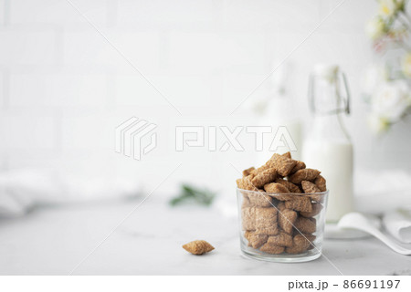Sweet corn pads with chocolate and milk in a glass cup 86691197